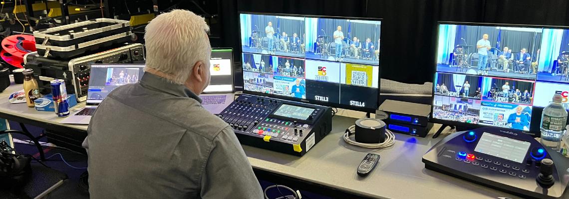audio visual rental near syracuse ny man sitting at desk working av equipment rental